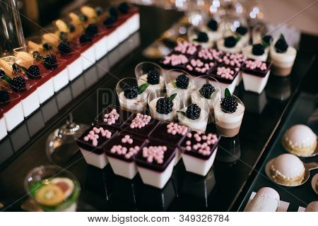 Sweer Food. Beautiful Candy Bar With Delicious  Cakes At A Wedding Party