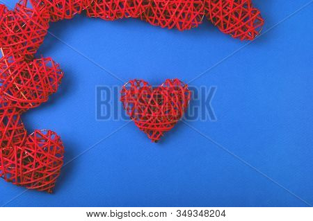 Beautiful Pattern Of The Red Wicker Hearts On The Cornflowerblue Background. St Valentines Concept F