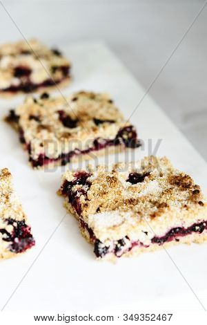 Honeysuckle Crumble Cake Sliced Into Pieces On Grey Marble Tray. Homemade Streusel Berries Pie.  Sel