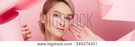 Panoramic Shot Of Beautiful Young Wwoman With Pink Makeup In Torn Paper, On Pink