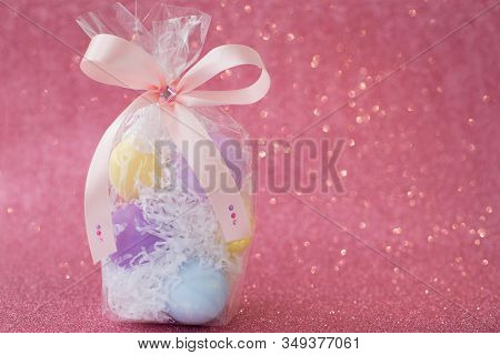 Multi-colored Purple, Pink, Blue, Yellow Easter Eggs In A Transparent Gift Package, Decorated With A