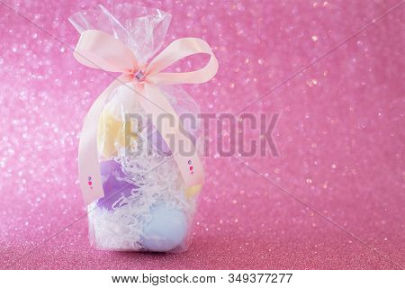 Multi-colored Purple, Pink, Blue, Yellow Easter Eggs In A Transparent Gift Package, Decorated With A