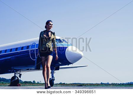 Charming Stewardess Dressed In Blue Uniform. Beautiful Stewardess. Traveling And Jet Plane Flying Co