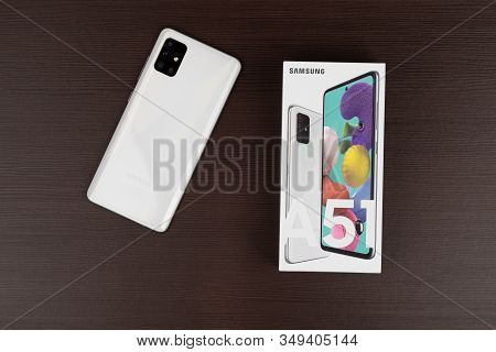 Rostov-on-don, Russia - January 2020. Samsung Galaxy A51 On A Wooden Background. Smartphone And Box 