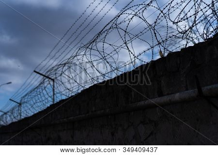 Barbed Wire Along The Fence.barbed Wire Along The Fence