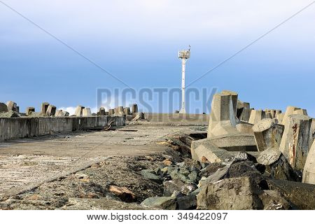 Dolos Concrete Barriers Besides An Abandoned And Collapsing Pier Battered From Pacific Storms Taken 