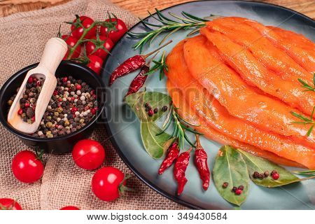 Raw marinated chicken legs for grill and bbq.Chicken legs in a red marinade on a cooking board. Pickled raw meat. Dietary meat. Cooking.Sottilissime
