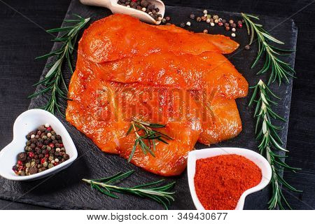 Raw marinated chicken legs for grill and bbq.Chicken legs in a red marinade on a cooking board. Pickled raw meat. Dietary meat. Cooking.Sottilissime