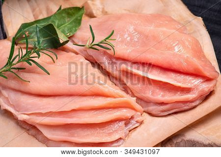 Raw sliced chicken meat close-up. Sotilissimo. Delicious dietary meat. Cooking,food of meat and fillets.Close-up view of raw, fresh, choped and sliced chicken meat.Sottilissime