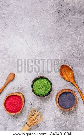 Different Colors Of Japanese Matcha Tea: Green, Red And Blue In Wooden Bowls On Gray Background. Aca
