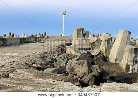 Dolos Concrete Reinforcements On The Side Of A Collapsing Weathered Pier Battered By Pacific Storms 