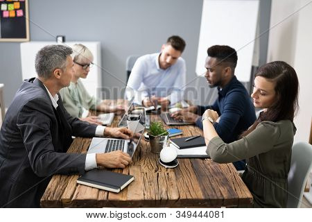 Woman Checking Time While Sitting In A Boring Long Meeting