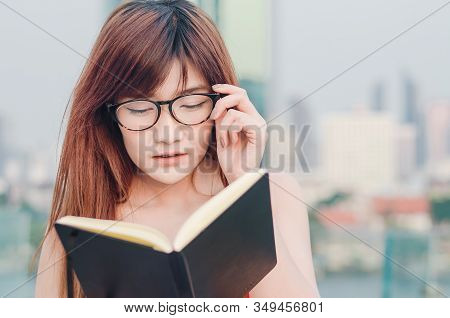 Closeup Portrait Of Attractive Female With Eyeglasses In Hand. Poor Young Girl Has Issues With Visio