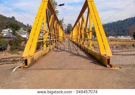 Yellow Steel Bridge Over River In Himachal Pradesh In Kangra Village, India