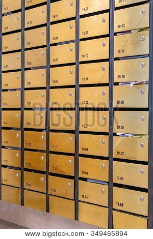 Metallic Letter Mailbox Array At Condominium Entrance Hall