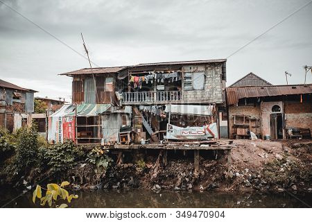 Manado, North Sulawesi, Indonesia - August 3, 2015: View Of A Ghetto By A River With Pollution, The 