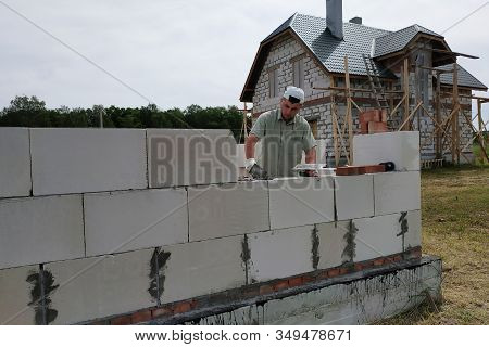 Laying The Wall Of Gas Blocks With Tools And Glue.