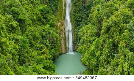 Waterfall In The Rainforest Jungle From Above. Tropical Mantayupan Falls In Mountain Jungle. Philipp