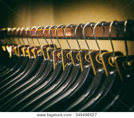 Lot Of Plastic Black Hangers On The Bar. Concept Store, Sale, Design, Empty Hangers.