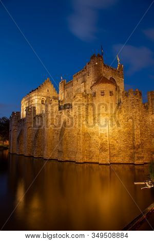 Granvensteen Castle In Ghent Belgium Lit Up At Night. Portrait Orientation