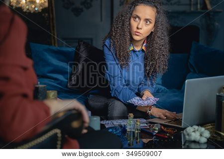 Serious Soothsayer Gazing At Her Female Client