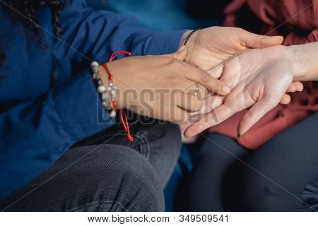 Female Chiromancer Reading Her Clients Palm Lines