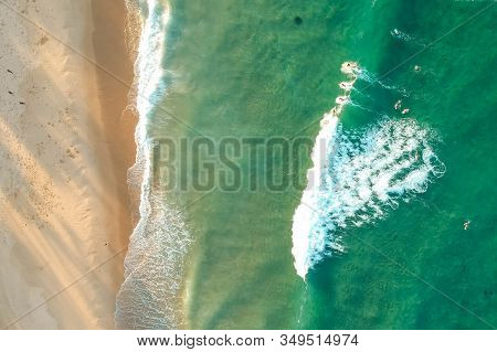 Top View Drone Shot Of Green Water With Surfer