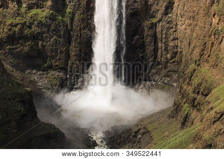 Close-up Of Stunning Waterfall Running Down A Steap Canyon