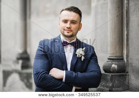 Happy Handsome Smiling Groom Posing With Boutonniere