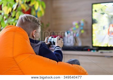 Young Gamer Boy Playing Online Car Racing Game On New Console At Home Tv - Little Kid Having Fun Usi
