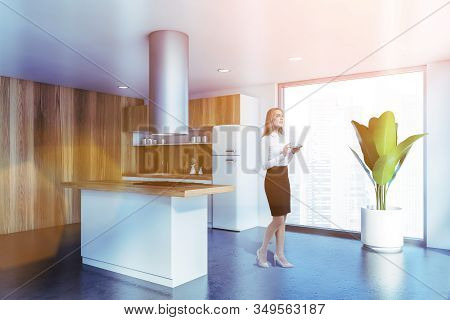Blonde Woman In White And Wooden Kitchen