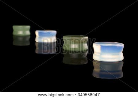 Group Of Four Whole Plug Diagonal Isolated On Black Glass