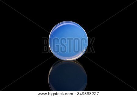 One Whole Blue Plug Isolated On Black Glass