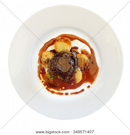 Fillet mignon steak with potatoes shot from above, isolated on white background