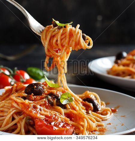 Pasta Alla Puttanesca - Spaghetti With Tomato Sauce Olives And Capers