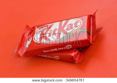 Kit Kat Chocolate Bar In Red Wrapping Lies On Red Background. Kit Kat Created By Rowntrees Of York I
