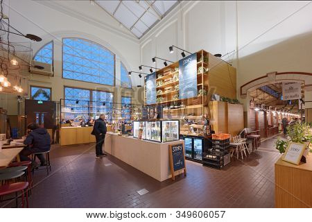 Helsinki, Finland - January 6, 2020: People  in the cafe of Old cdecorated for Christmas. The building was opened for customers in 1889
