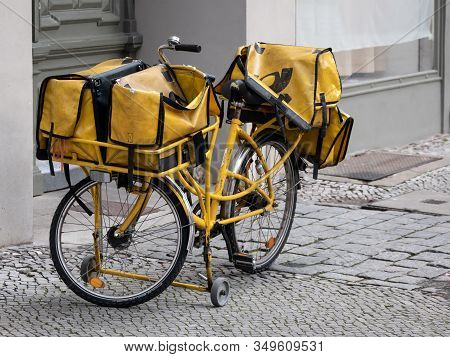 Berlin, Germany - February 4, 2020: Official Black And Yellow Bicycle Of German Deutsche Post, Stand