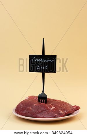 A Fork Is Stuck In A Piece Of Raw Meat. Veal Tenderloin. Carnivore Diet Label. Zero Carb Diet Concep
