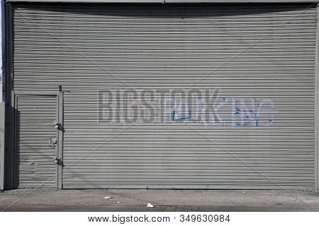 Generic Roll Up Door. Garage or Warehouse with a Roll Up Door. Building entrance with a large steel security door. Los Angeles California or any part of the world uses doors to keep things safe. 