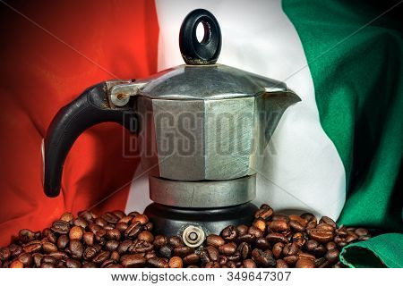 Close-up Of An Old Coffee Maker (moka Pot, Side View) On A Stack Of Roasted Coffee Beans With The It