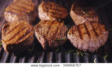 Delicious Juicy Meat Steak Cooking On Grill. Prime Beef Fry On Electric Roaster, Rosemary, Black Pep