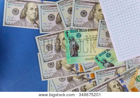 Tax Retrun Check With 100 Dollar Bills Usa Currency And Spiral Notepad