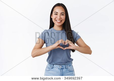 Cheerful, Friendly And Enthusiastic Charming Asian Girlfriend Saying I Love You, Showing Heart Sign 