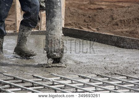 The Process Of Pouring Concrete At A Construction Site. Concreting The Base Of A Building Under Cons