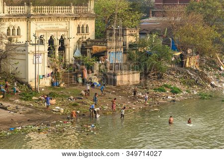 Kolkata, India - March 11, 2019: Indian People Bathing In River Hooghly Or Ganga At Mallick Ghat. Vi