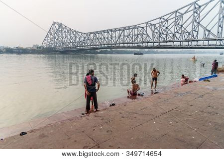 Kolkata, India - March 11, 2019:indian People Bathing In River Hooghly Or Ganga At Mallick Ghat In E
