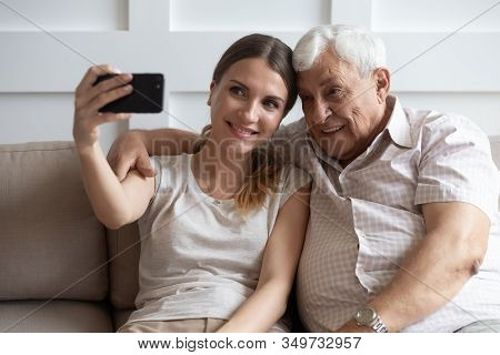 Happy Elderly Father And Adult Daughter Make Selfie Together