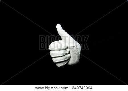 A Hand Wearing White Glove On Black Background Showing That Everything Is Ok