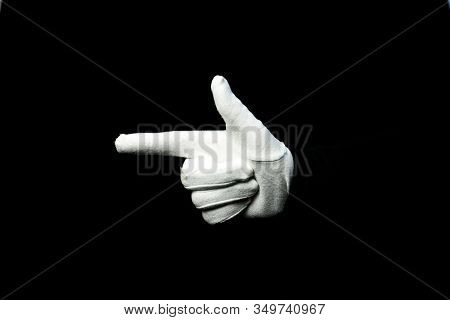 A Hand Wearing White Glove On Black Background Showing A Gun Symbol